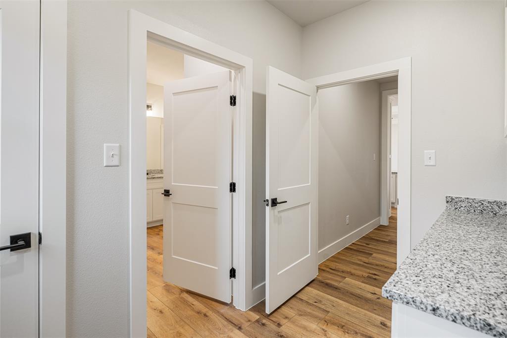502 Limestone Circle Mabank, TX 75147 - Photo 21 of 38 a view of a hallway with the door and wooden cabinets