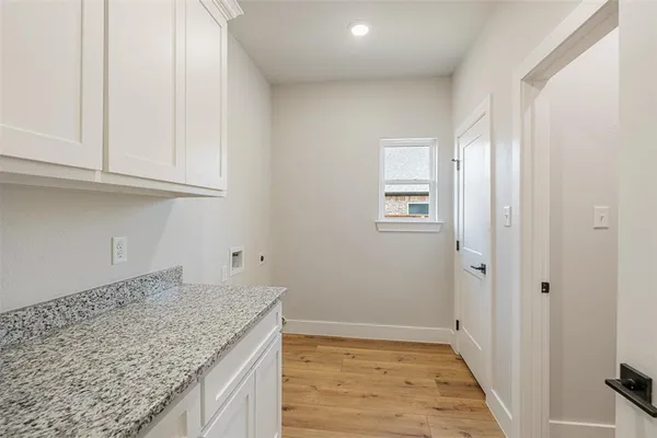 a kitchen with granite countertop sink and cabinets