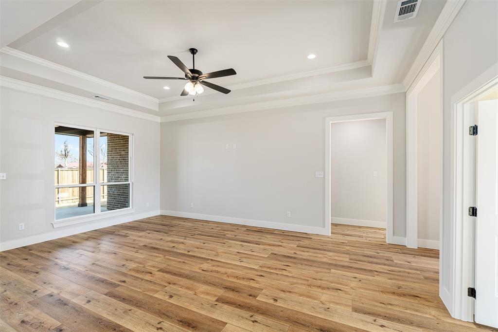 502 Limestone Circle Mabank, TX 75147 - Photo 4 of 38 a view of an empty room with wooden floor and a window