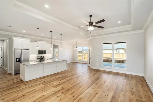 a kitchen with stainless steel appliances kitchen island hardwood floor sink stove and wooden floor