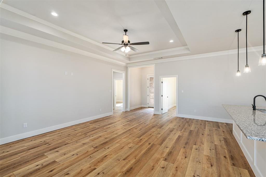 502 Limestone Circle Mabank, TX 75147 - Photo 5 of 38 a view of empty room with wooden floor and fan