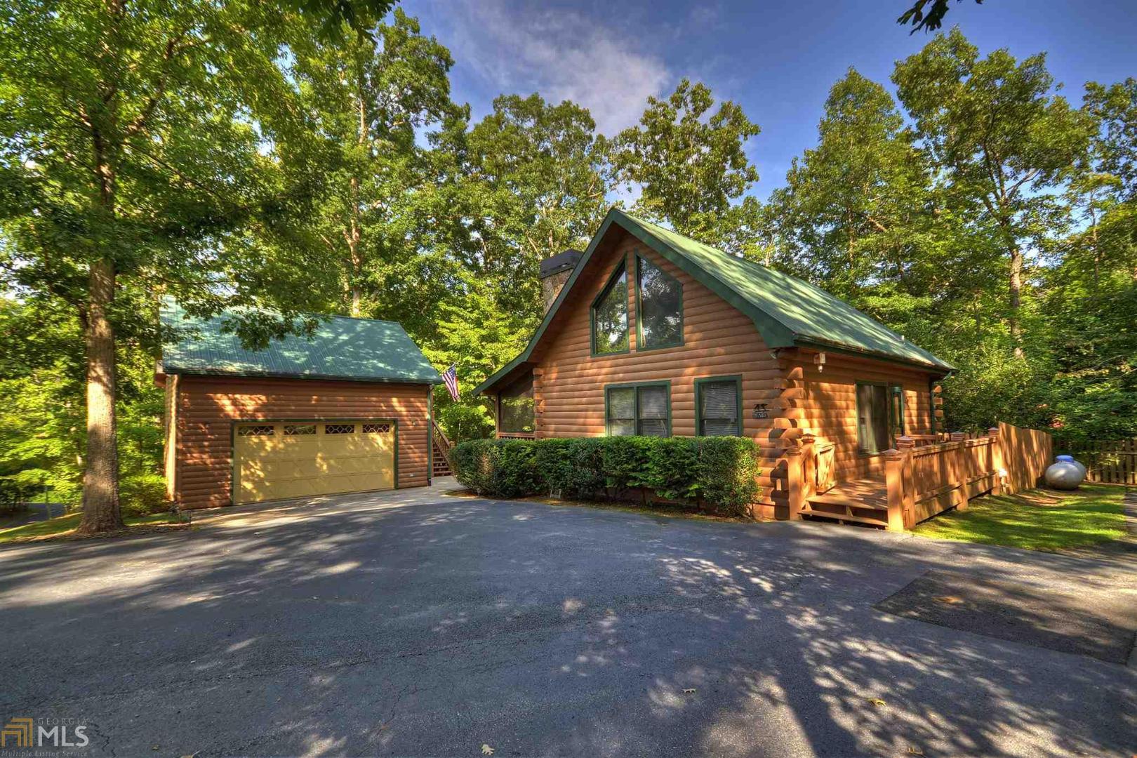 a view of a house with a yard and tree s