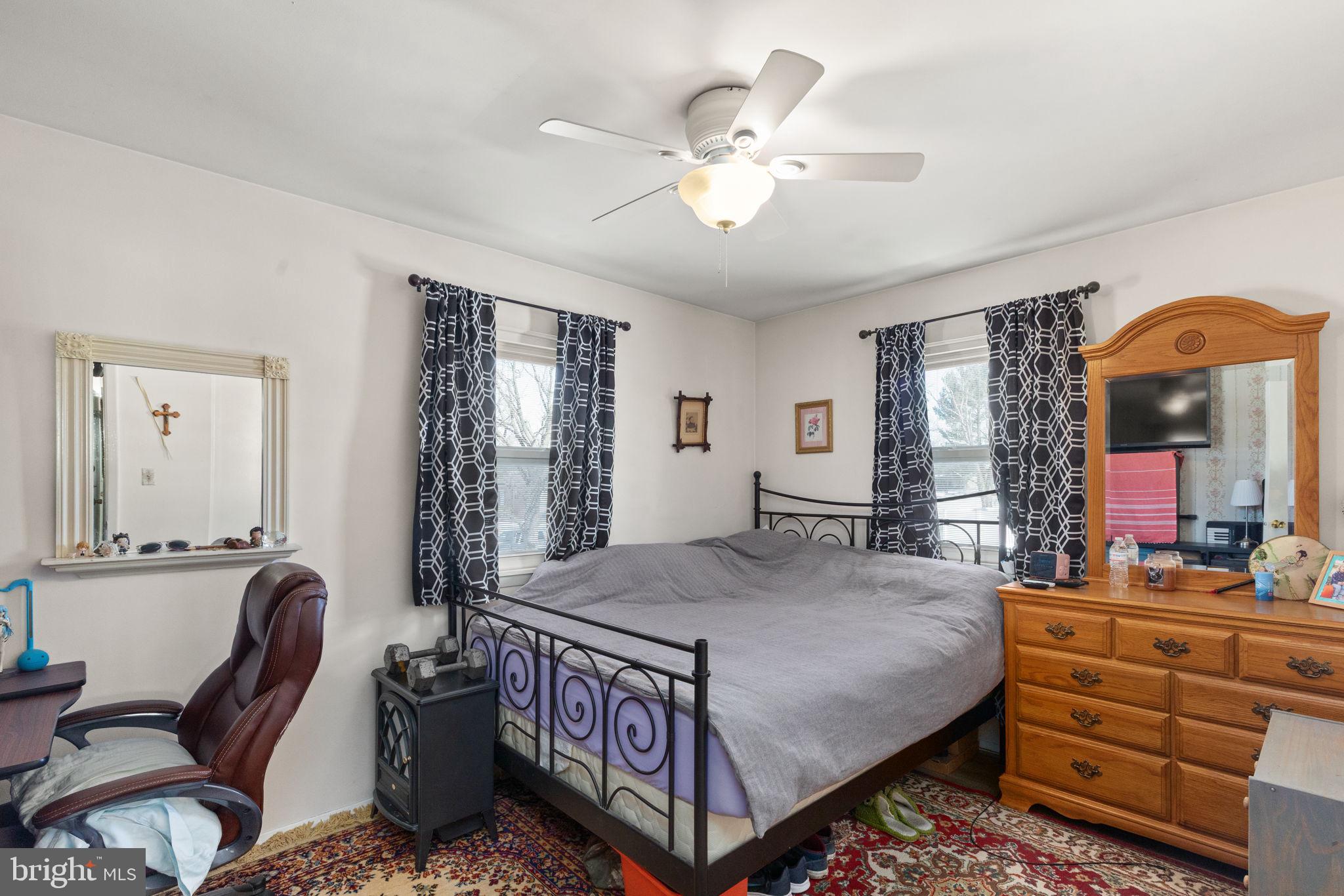 3409 Acton Road Parkville, MD 21234 - Photo 18 of 27 a bedroom with a bed a dresser and chair