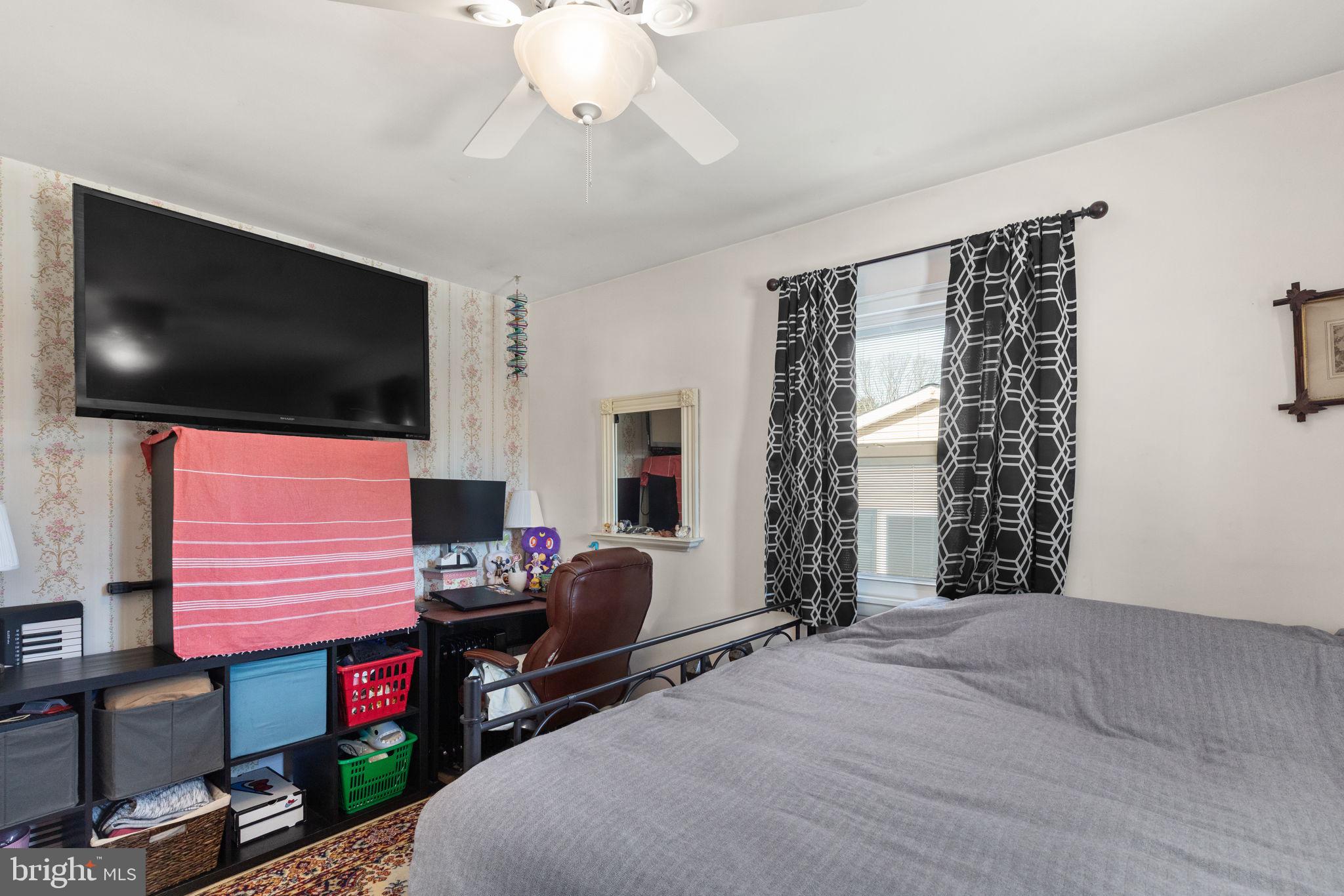3409 Acton Road Parkville, MD 21234 - Photo 19 of 27 a bedroom with a bed and a flat screen tv