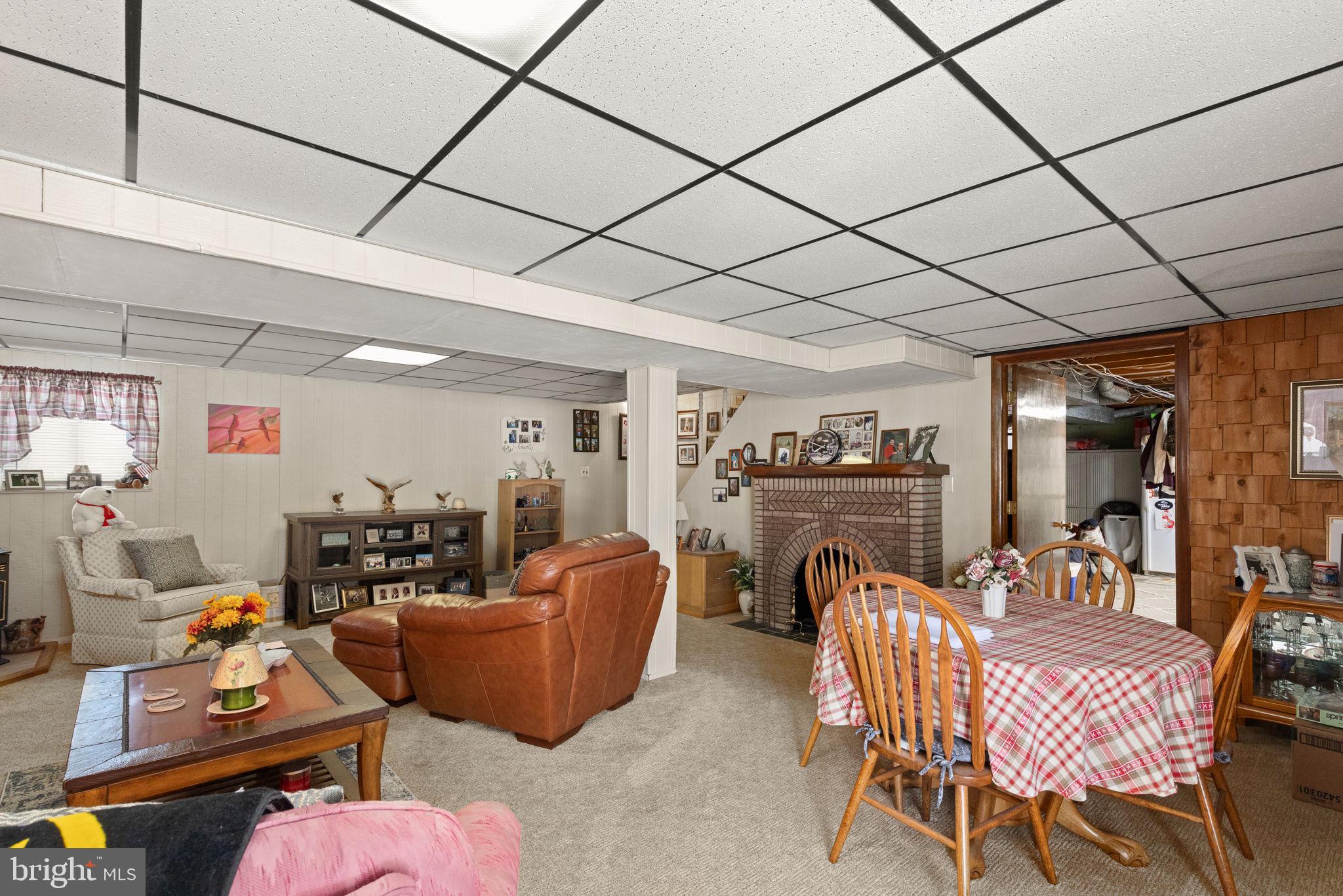 3409 Acton Road Parkville, MD 21234 - Photo 24 of 27 a dining room with furniture a fireplace and a chandelier