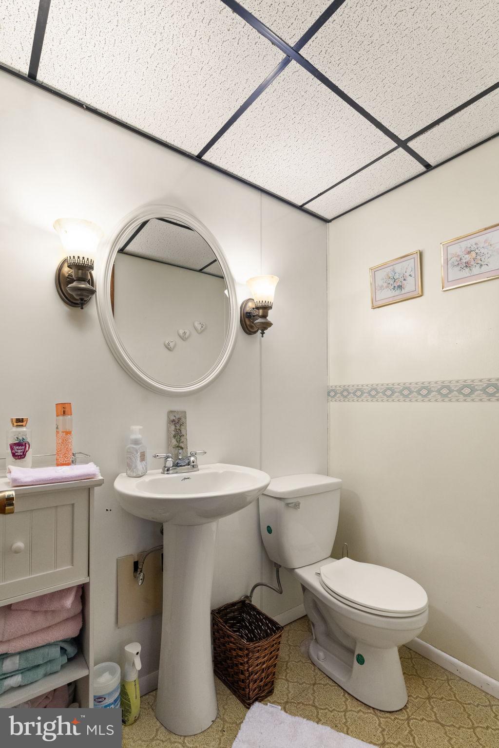 3409 Acton Road Parkville, MD 21234 - Photo 25 of 27 a bathroom with a toilet sink and mirror