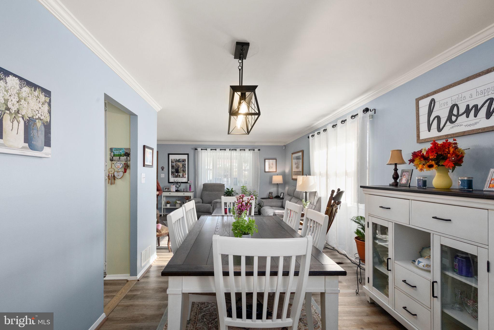 3409 Acton Road Parkville, MD 21234 - Photo 7 of 27 a view of a dining room with furniture a chandelier and wooden floor