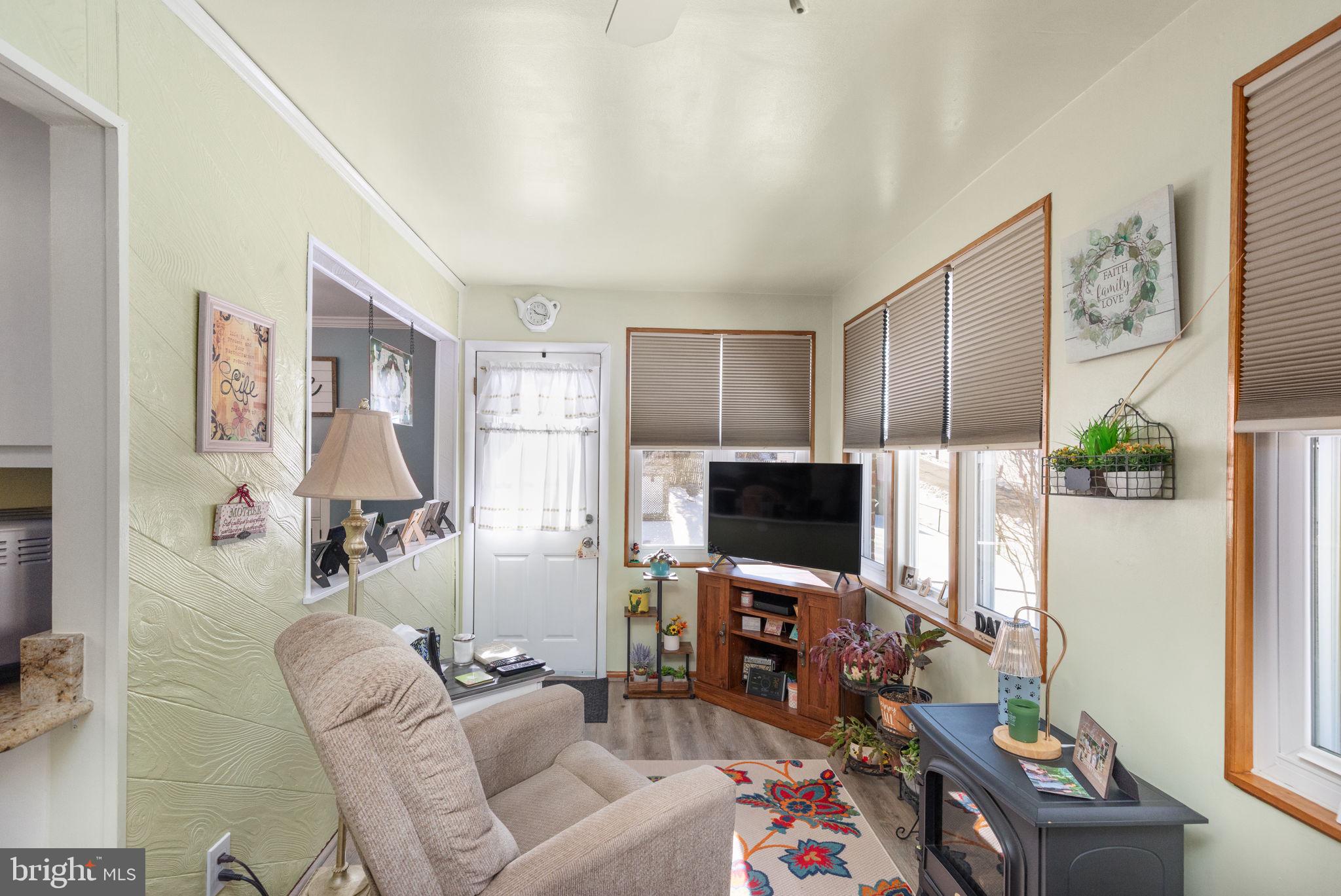 3409 Acton Road Parkville, MD 21234 - Photo 10 of 27 a living room with furniture and a flat screen tv