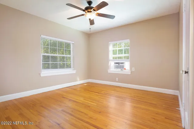 a view of a backyard with large trees
