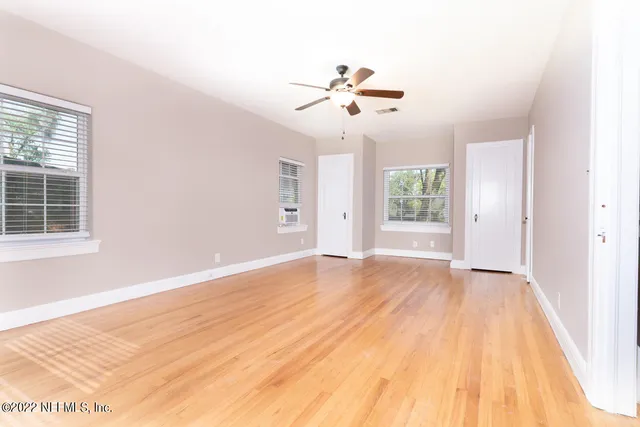 a bathroom with a toilet sink vanity and mirror