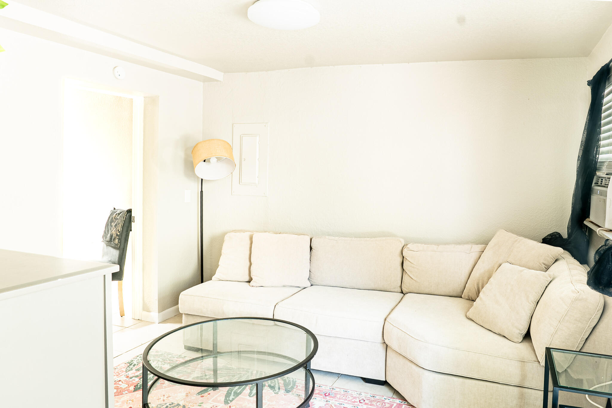 205 Coral Road, Unit 1 Boynton Beach, FL 33435 - Photo 5 of 9 a living room with a couch and a chandelier
