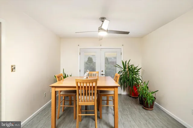 a kitchen with stainless steel appliances kitchen island granite countertop a sink and dishwasher a refrigerator with wooden floor