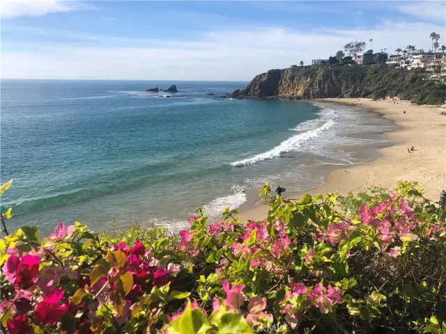 a view of a house with a small yard and wooden floor