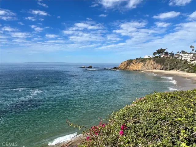 a view of a white house with swimming pool in front of it