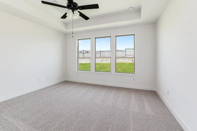a view of room with window and ceiling fan
