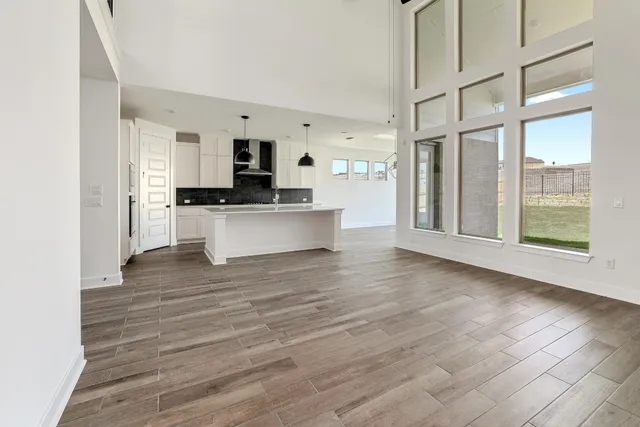 a view of kitchen with stainless steel appliances kitchen island wooden floor and window