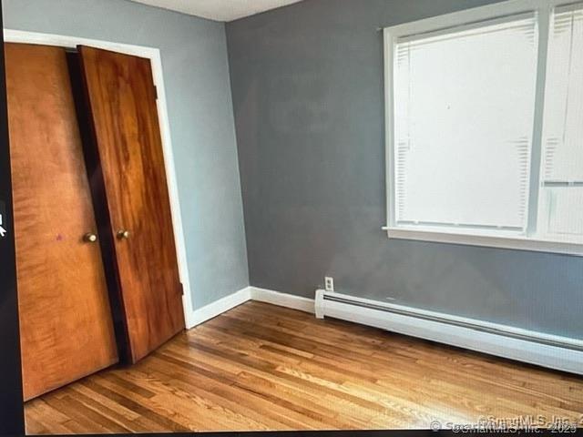 555 Frost Road Waterbury, CT 06705 - Photo 5 of 11 a view of a small space with wooden floor and a window