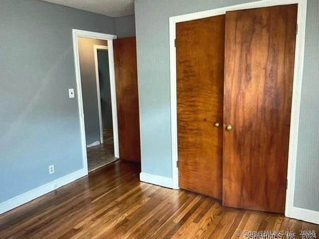 555 Frost Road Waterbury, CT 06705 - Photo 6 of 11 an empty room with wooden floor and closet area