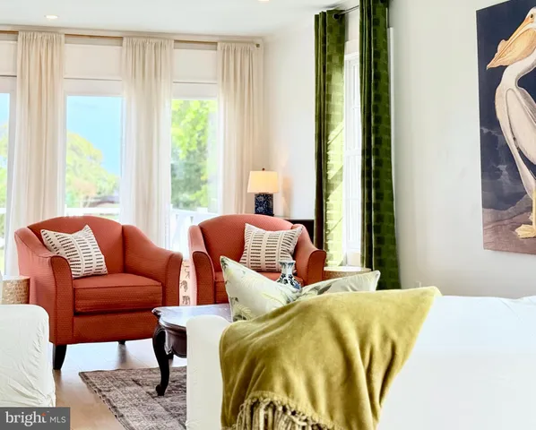 a bedroom with two beds and a large window