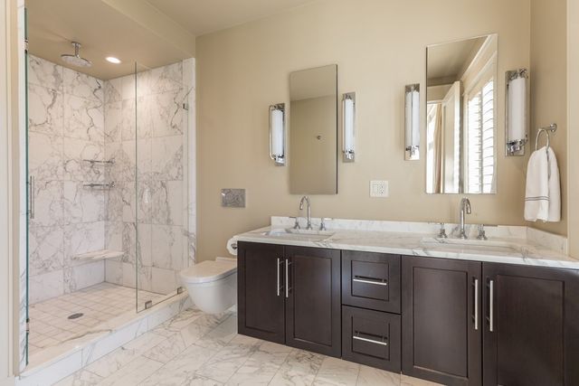 a bathroom with a granite countertop sink mirror and shower