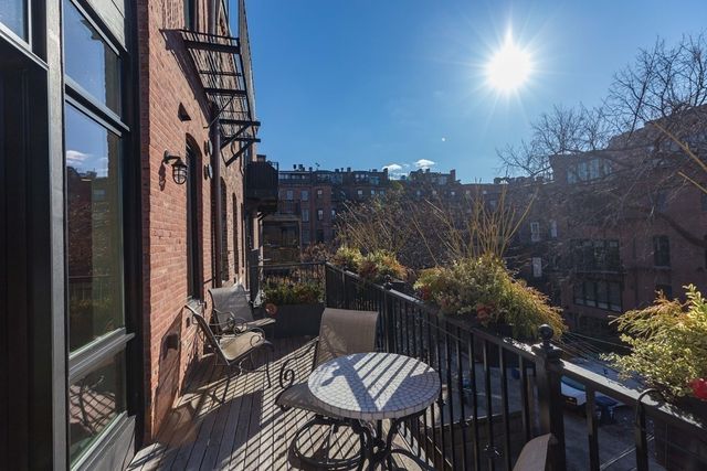 a view of a balcony with chairs and a table
