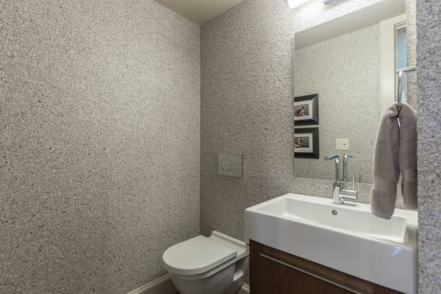 a bathroom with a sink a toilet and mirror