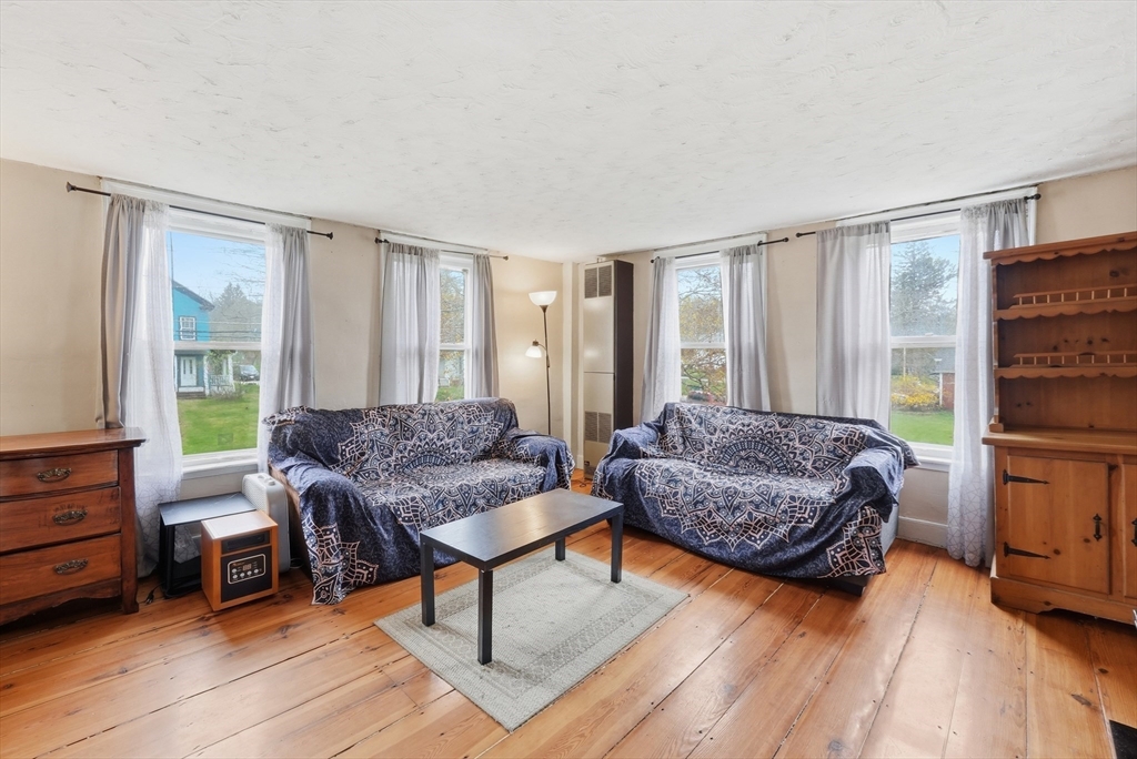 16 Main Street Brookfield, MA 01506 - Photo 23 of 45 a living room with furniture and a large window