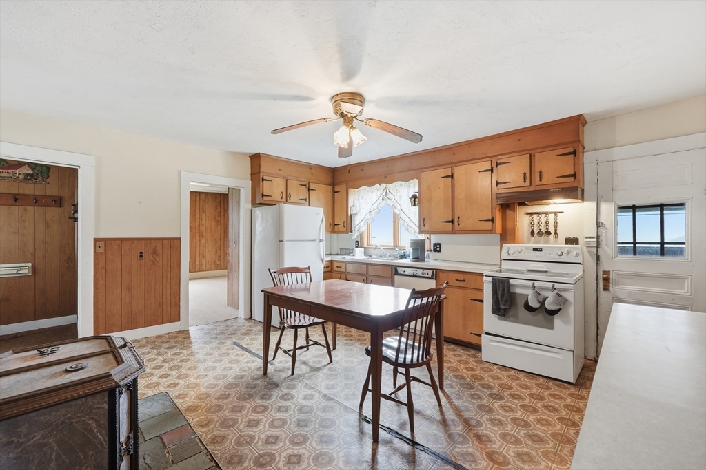 16 Main Street Brookfield, MA 01506 - Photo 5 of 45 a kitchen with stainless steel appliances a stove a refrigerator and a dining table