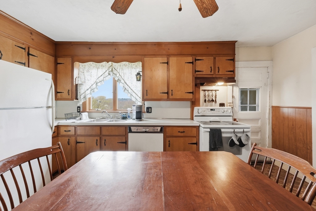 16 Main Street Brookfield, MA 01506 - Photo 7 of 45 a kitchen with stainless steel appliances granite countertop a refrigerator a sink dishwasher a stove and white countertops with wooden floor