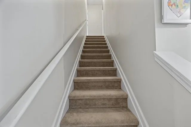 a hallway with wooden floor and entryway