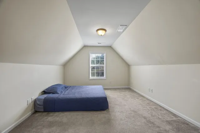 a living room with furniture and a view of kitchen