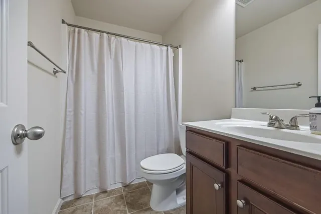 a bedroom with a bed dresser and a window