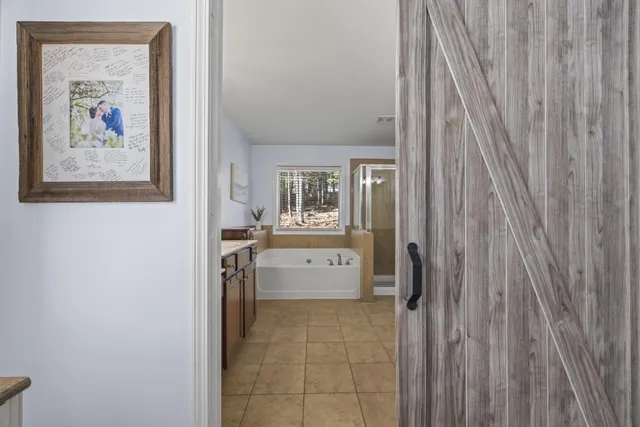 a view of walk in closet with clothes