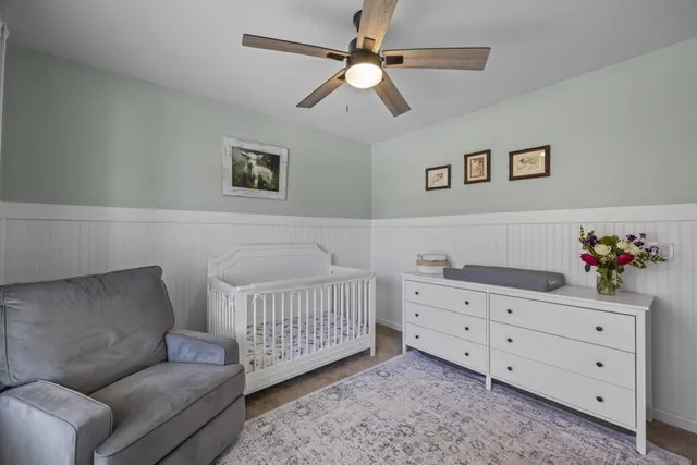 a bathroom with a granite countertop sink toilet and a mirror