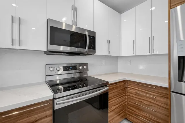 a view of kitchen with refrigerator and window
