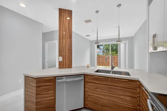 a view of a livingroom with wooden floor and a sink