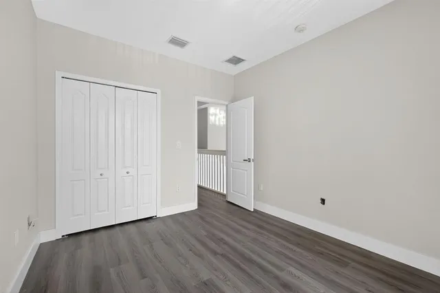 a view of wooden floor and windows in a room