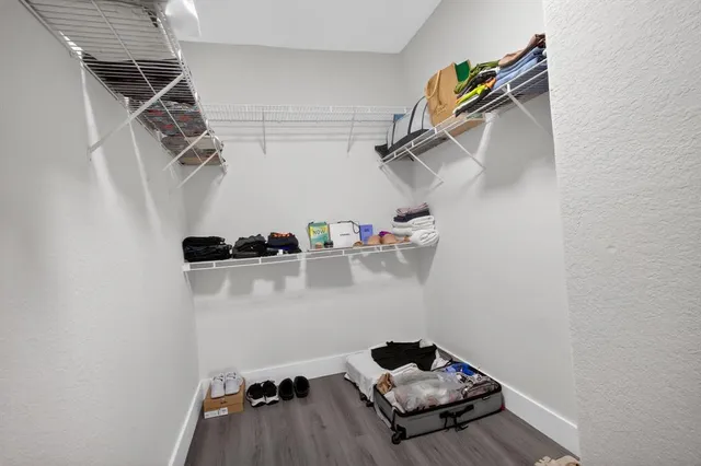 a view of backyard with potted plants and wooden fence