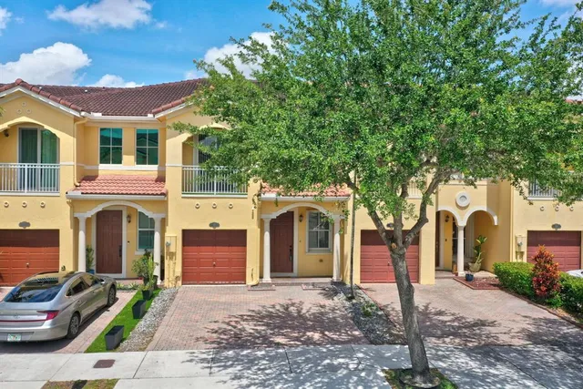 an aerial view of residential houses with outdoor space