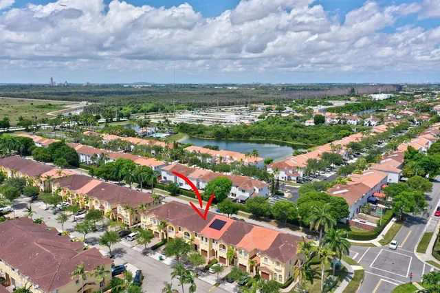 an aerial view of multiple houses with a yard