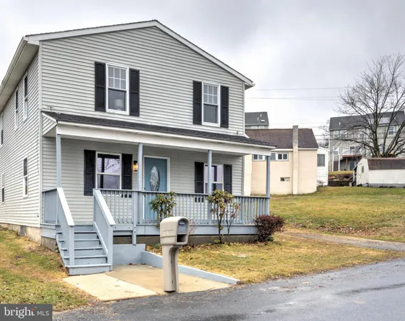 a view of a house with wooden fence