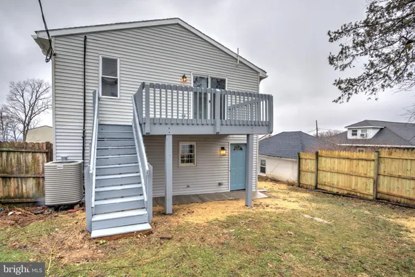 a view of a balcony with wooden floor and fence