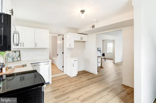 a kitchen with a refrigerator and a stove top oven