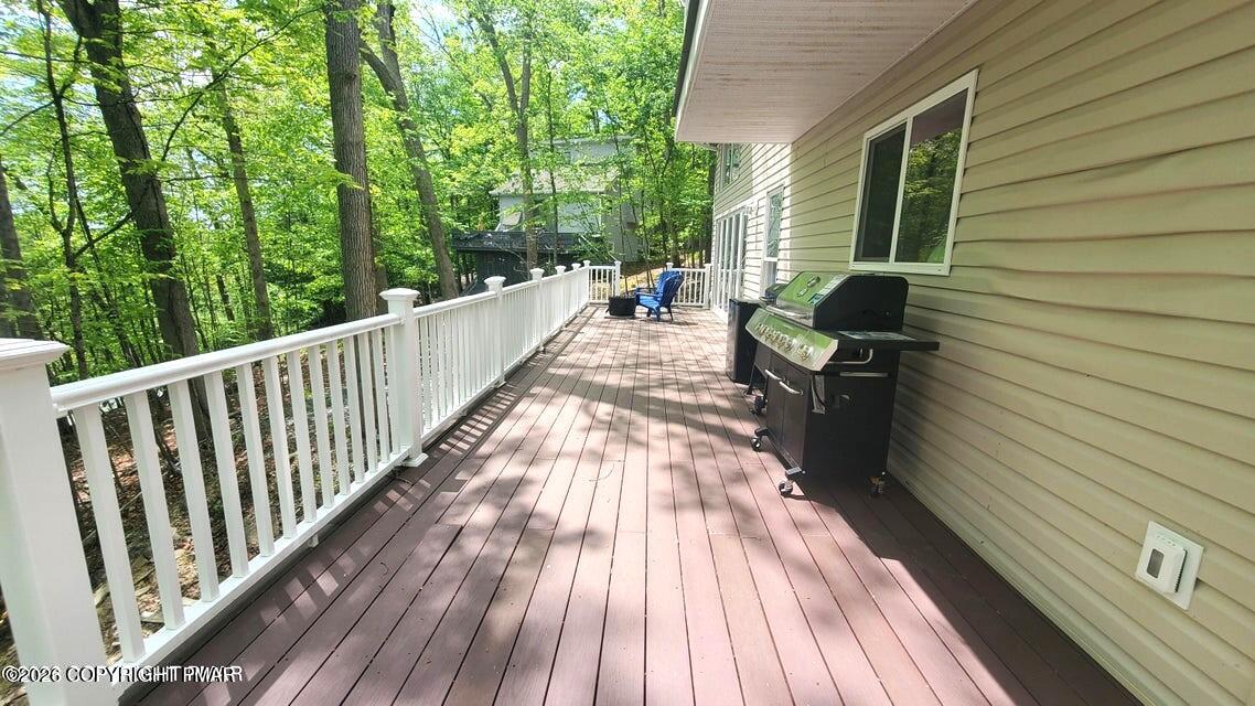 5873 Decker Road Bushkill, PA 18324 - Photo 24 of 57 a view of balcony with chairs and wooden floor