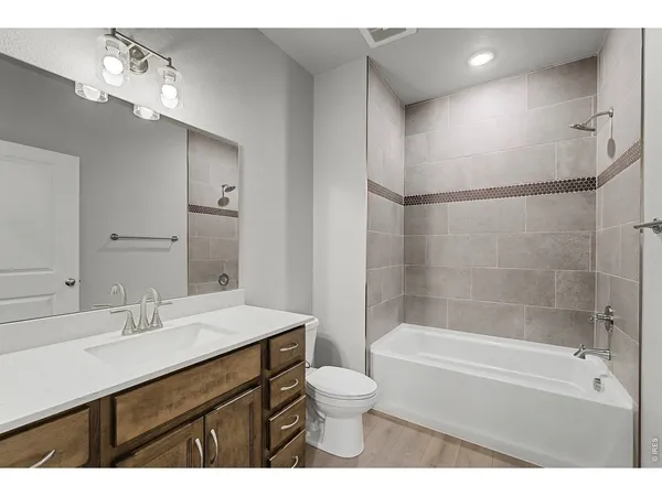 a bathroom with a sink toilet a mirror and shower