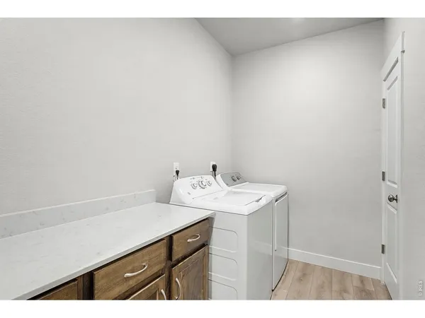 a utility room with a sink dryer and washer