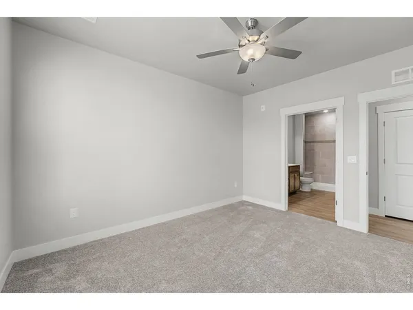 a view of an empty room with a ceiling fan
