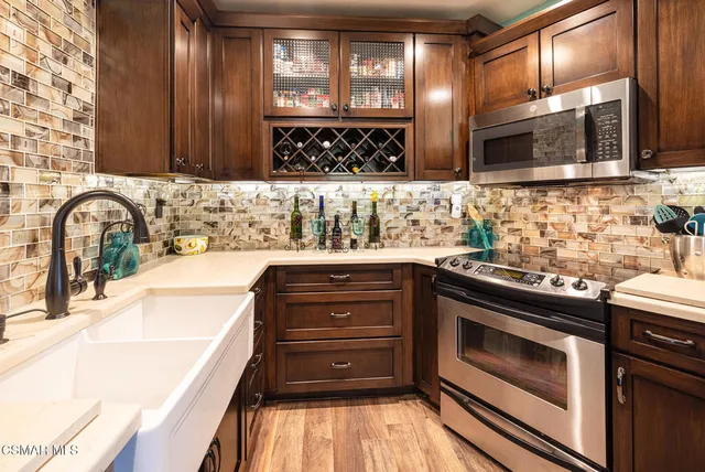 a kitchen with a sink stove and microwave