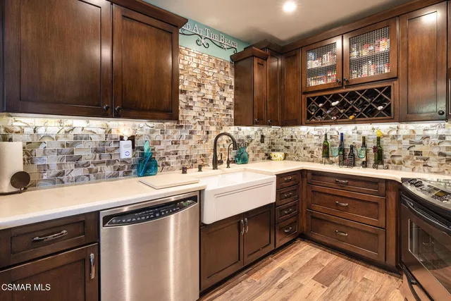 a kitchen with stainless steel appliances wooden cabinets and a sink