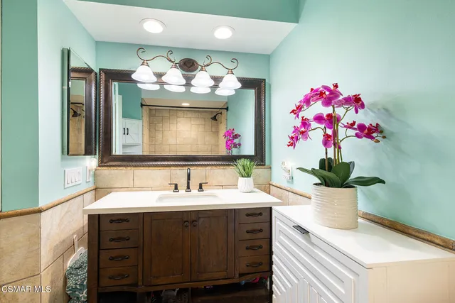 a bathroom with a sink vanity and a mirror